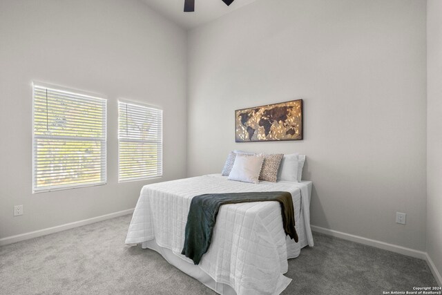 bedroom with ceiling fan and carpet floors