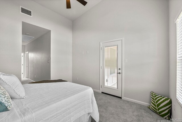 carpeted bedroom featuring ceiling fan and high vaulted ceiling