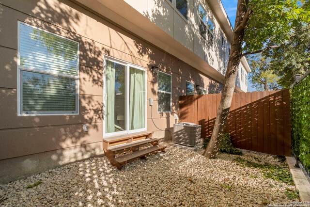 view of side of property featuring central AC