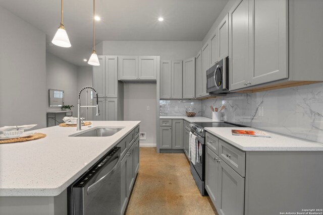 kitchen with gray cabinetry, sink, tasteful backsplash, decorative light fixtures, and appliances with stainless steel finishes