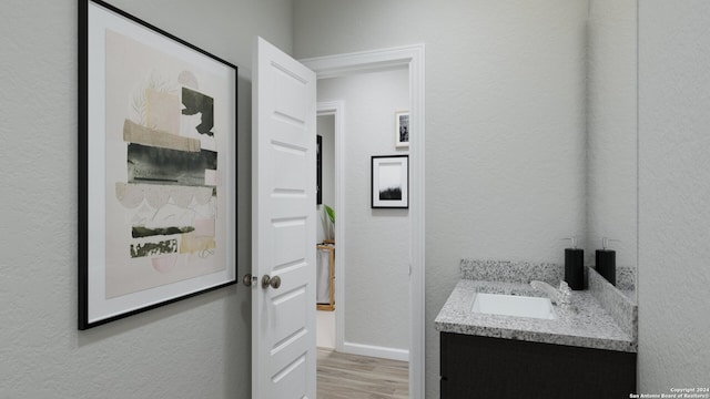 bathroom with vanity and wood-type flooring