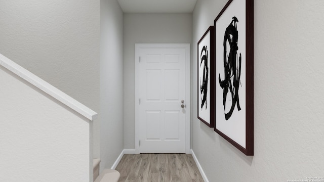 corridor with light hardwood / wood-style floors