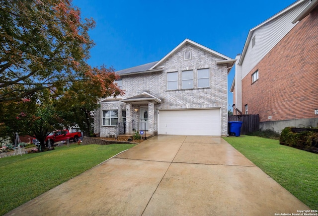 front facade with a garage and a front lawn