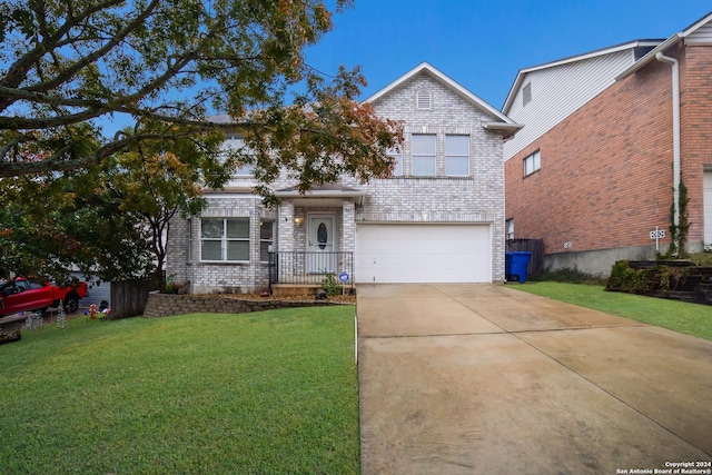 view of front of house with a front yard and a garage