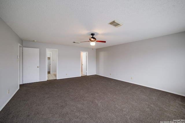 unfurnished room featuring ceiling fan, light colored carpet, and a textured ceiling