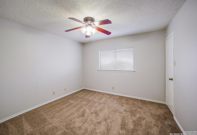 spare room featuring ceiling fan, carpet floors, and a textured ceiling