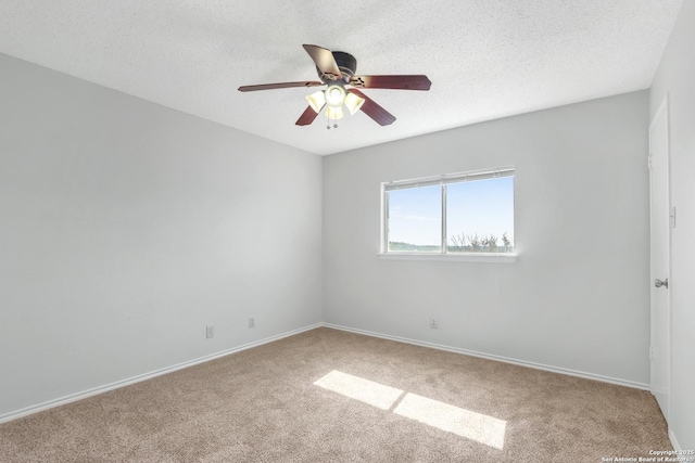 carpeted spare room featuring ceiling fan and a textured ceiling