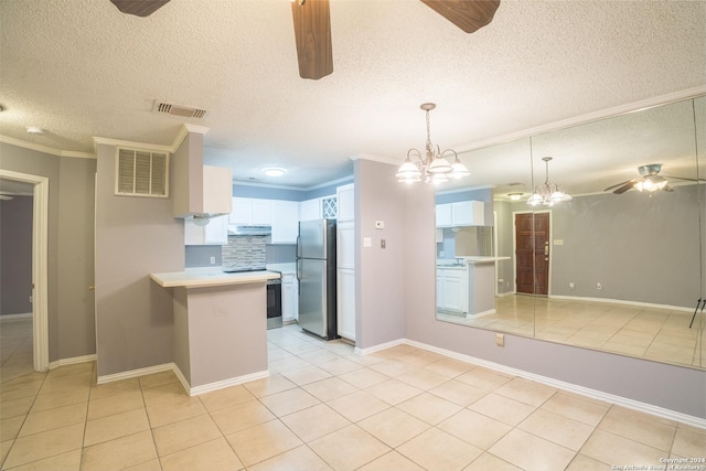 kitchen with stainless steel appliances, light tile patterned floors, backsplash, crown molding, and white cabinets