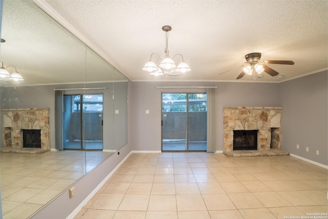 unfurnished living room featuring ceiling fan with notable chandelier, a stone fireplace, light tile patterned floors, and a textured ceiling