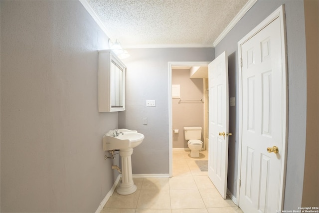 bathroom with tile patterned floors, toilet, crown molding, and a textured ceiling