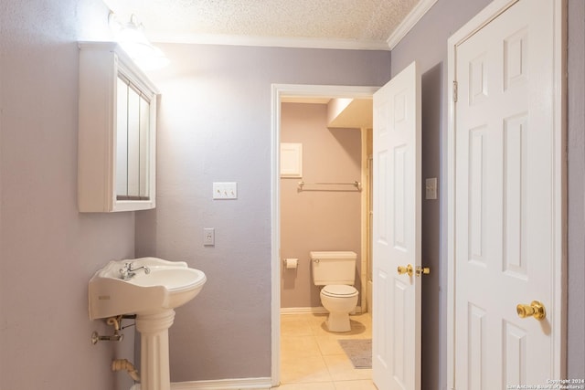 bathroom featuring crown molding, tile patterned flooring, a textured ceiling, and toilet