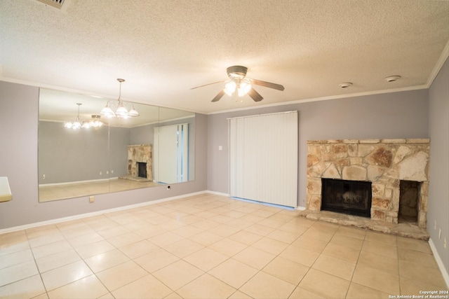 unfurnished living room featuring ceiling fan with notable chandelier, a stone fireplace, ornamental molding, a textured ceiling, and light tile patterned floors