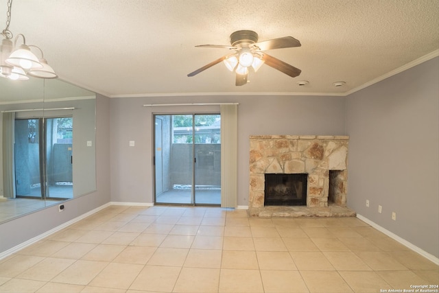 unfurnished living room with a textured ceiling, a fireplace, ceiling fan with notable chandelier, and ornamental molding