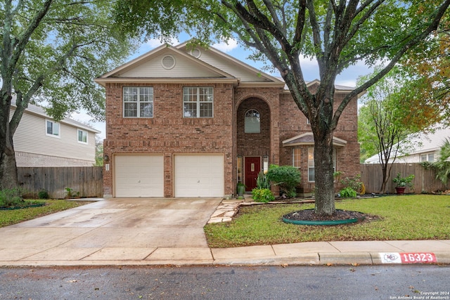 view of front of property featuring a garage and a front yard