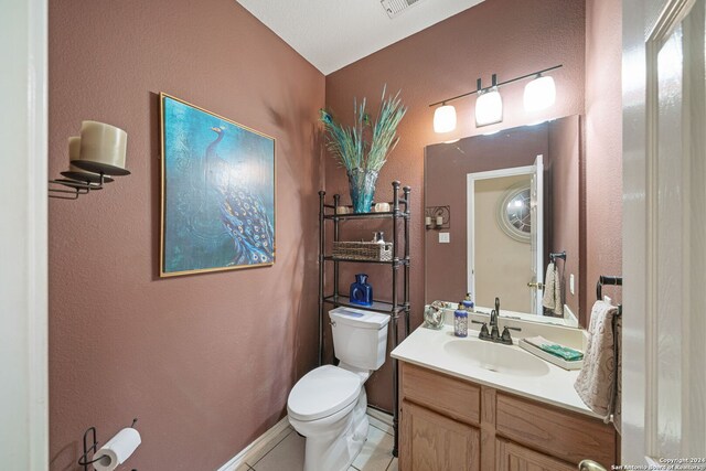 bathroom with tile patterned floors, vanity, and toilet