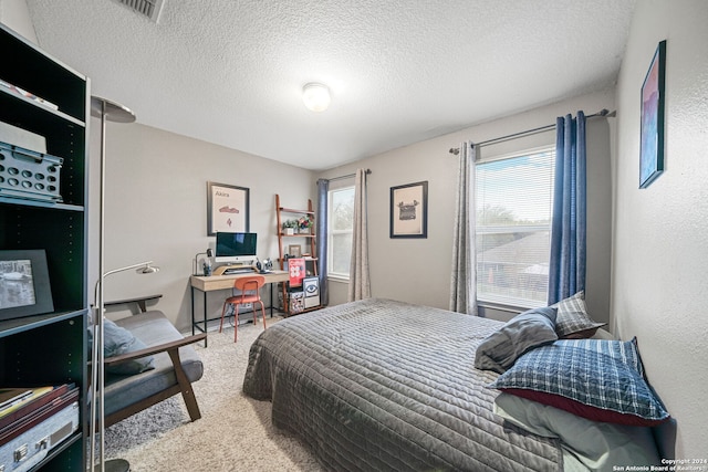 bedroom featuring carpet flooring and a textured ceiling