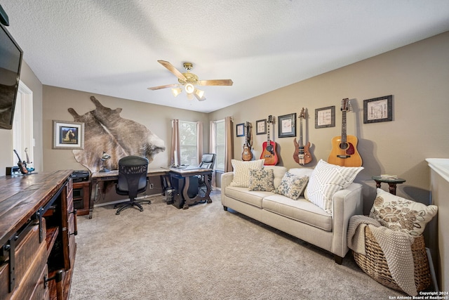 carpeted office space featuring ceiling fan and a textured ceiling