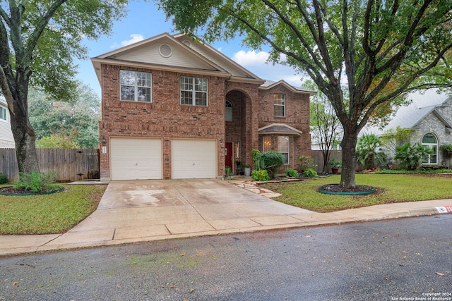 view of front of home with a garage and a front yard