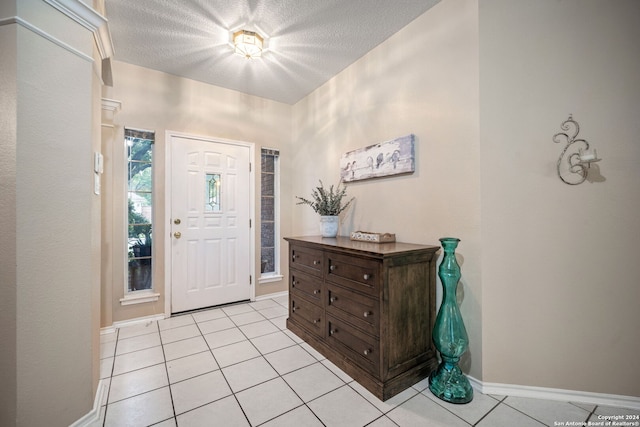 tiled foyer featuring a textured ceiling