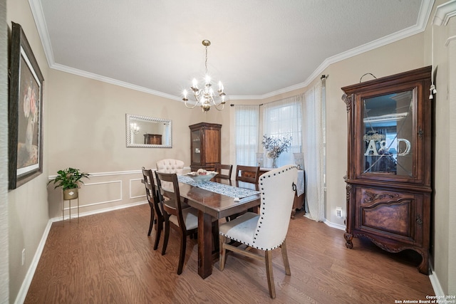 dining space with crown molding, dark hardwood / wood-style floors, and a notable chandelier