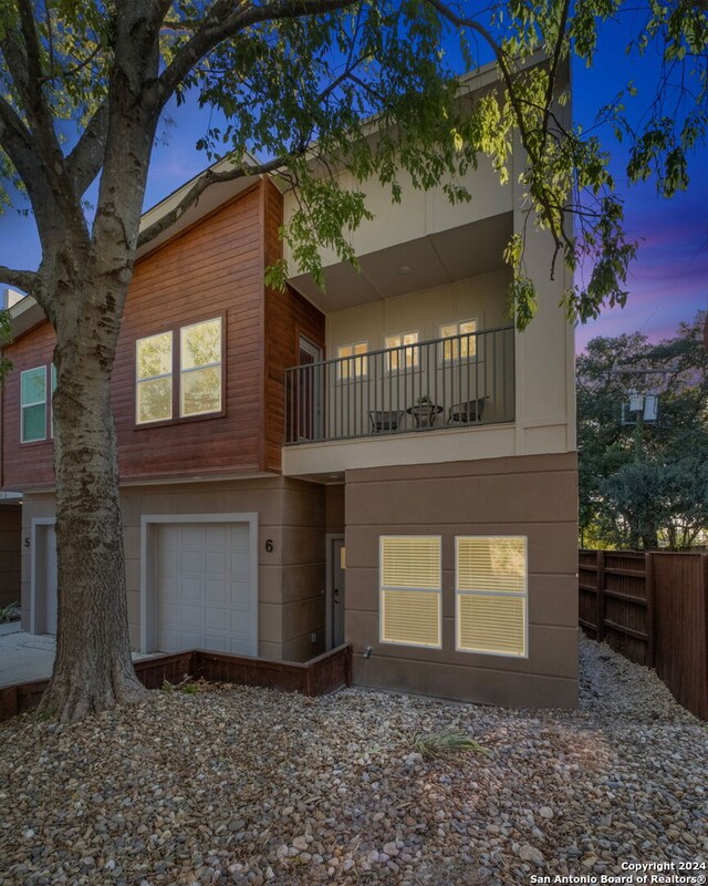 view of front of property with a balcony and a garage