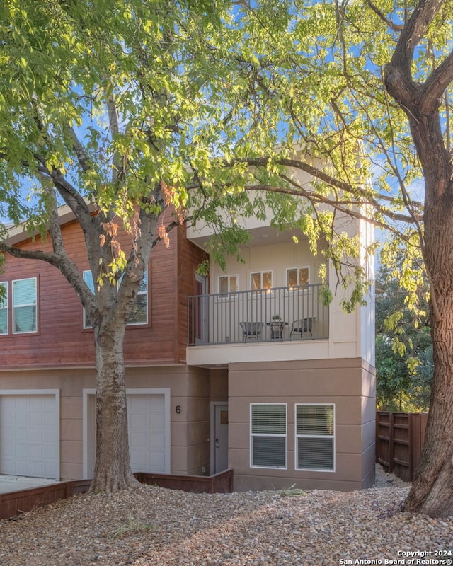 view of front of home featuring a balcony and a garage