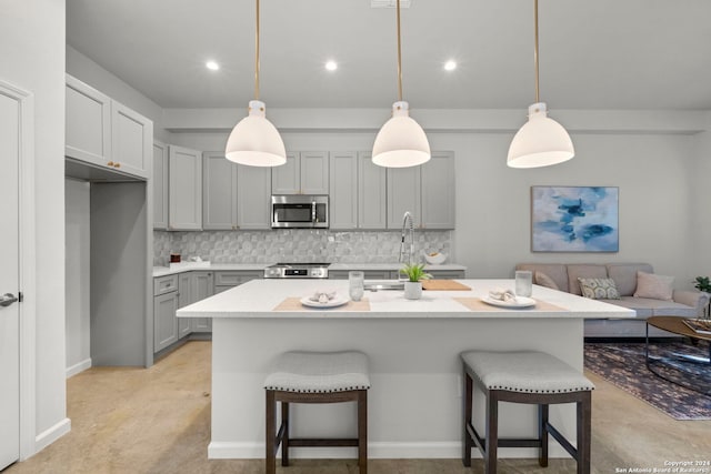 1002 Morningside Dr Unit 6, Terrell Hills, TX 78209 - kitchen featuring pendant lighting, gray cabinets, appliances with stainless steel finishes, and tasteful backsplash