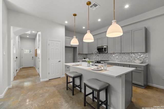 1002 Morningside Dr Unit 6, Terrell Hills, TX 78209 - kitchen featuring gray cabinetry, a kitchen island with sink, and decorative light fixtures
