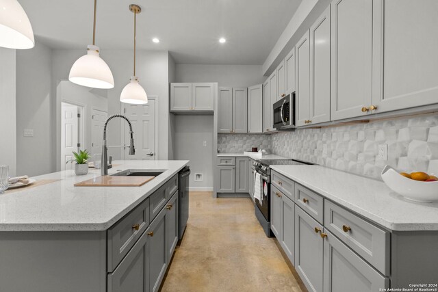 1002 Morningside Dr Unit 6, Terrell Hills, TX 78209 - kitchen featuring gray cabinetry, light stone countertops, sink, stainless steel appliances, and decorative light fixtures