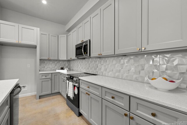 1002 Morningside Dr Unit 6, Terrell Hills, TX 78209 - kitchen featuring light stone countertops, gray cabinetry, decorative backsplash, and stainless steel appliances