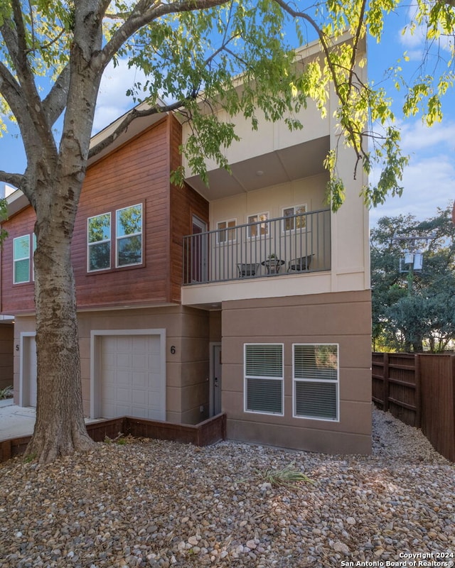 view of front of property with a balcony and a garage