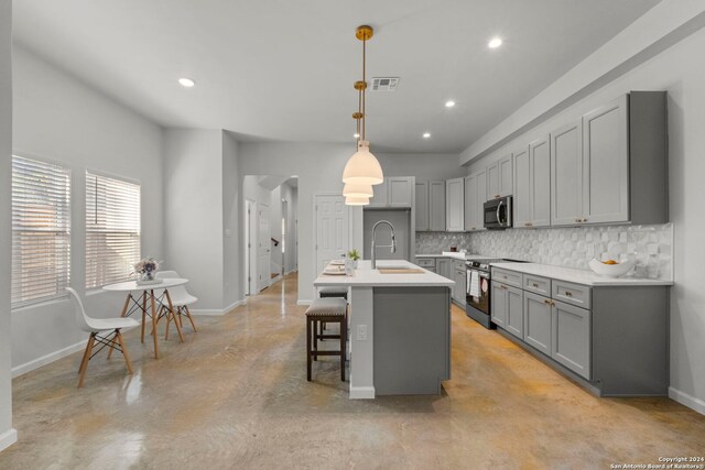 1002 Morningside Dr Unit 6, Terrell Hills, TX 78209 - kitchen featuring decorative backsplash, gray cabinetry, stainless steel appliances, pendant lighting, and a center island with sink