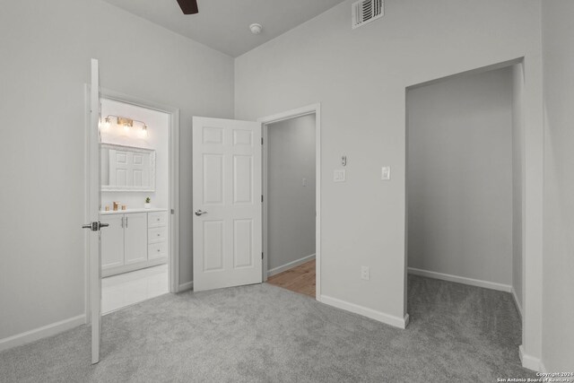 1002 Morningside Dr Unit 6, Terrell Hills, TX 78209 - unfurnished bedroom featuring ceiling fan, light carpet, and connected bathroom