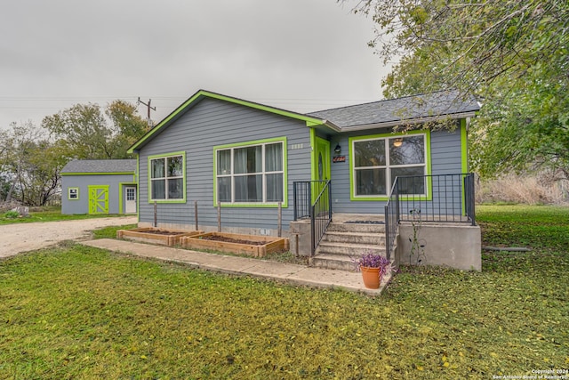 view of front facade featuring a front lawn and a storage unit