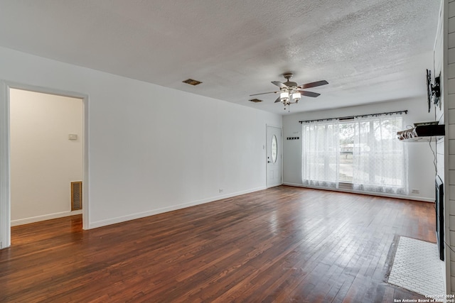 unfurnished living room featuring a textured ceiling, ceiling fan, and dark wood-type flooring