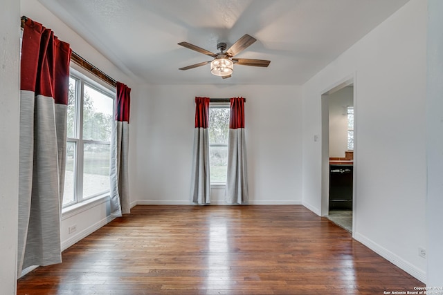 spare room featuring ceiling fan and dark wood-type flooring