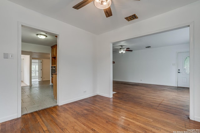 spare room with hardwood / wood-style flooring and ceiling fan