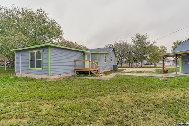 exterior space featuring central AC and a lawn