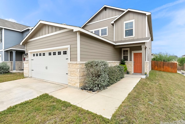 craftsman house with a front yard and a garage