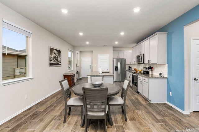 dining area with dark hardwood / wood-style flooring and sink