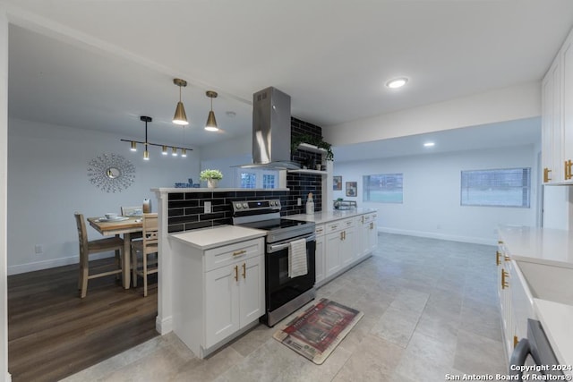 kitchen with hanging light fixtures, tasteful backsplash, island exhaust hood, stainless steel range with electric stovetop, and white cabinets