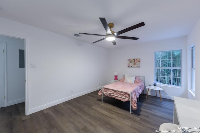 bedroom featuring electric panel, dark hardwood / wood-style floors, and ceiling fan