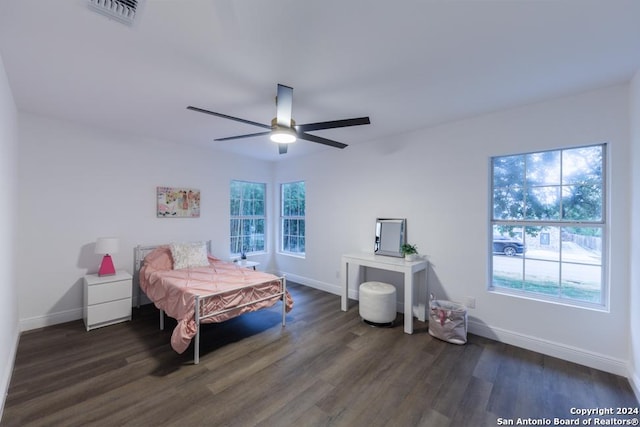 bedroom featuring multiple windows, ceiling fan, and dark wood-type flooring