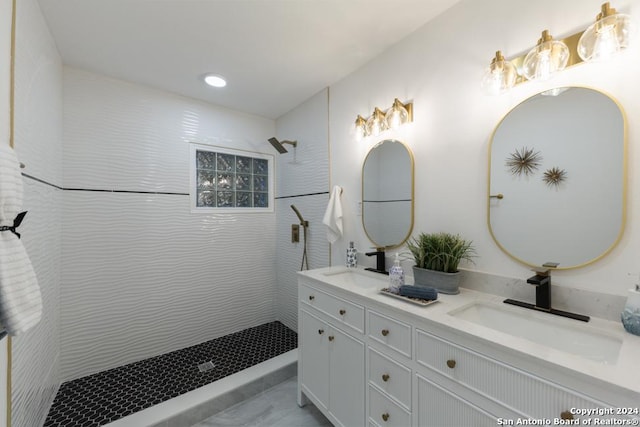 bathroom with vanity and tiled shower