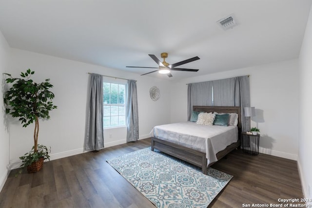 bedroom with ceiling fan and dark hardwood / wood-style flooring