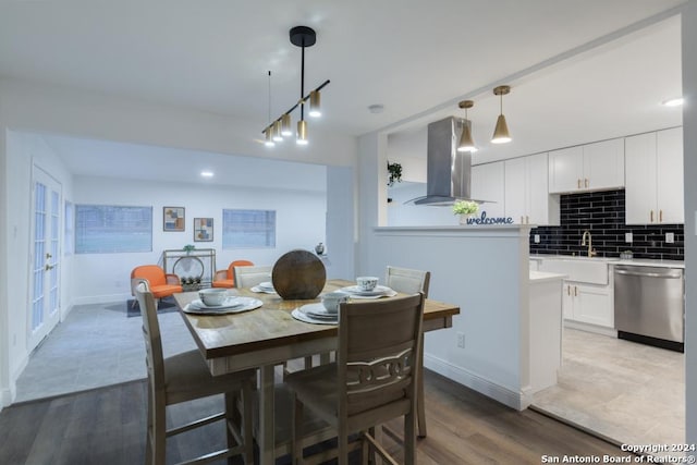 dining space with light wood-type flooring and sink