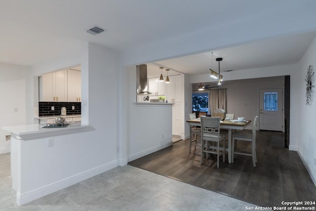 dining room with hardwood / wood-style flooring and ceiling fan