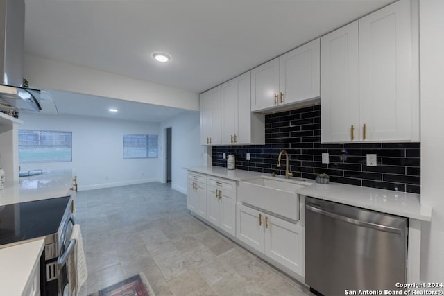 kitchen featuring decorative backsplash, white cabinetry, sink, and stainless steel appliances