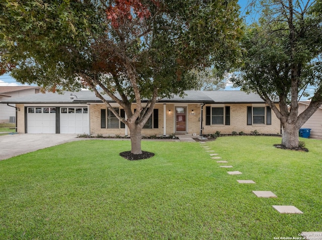 ranch-style house featuring a garage and a front yard