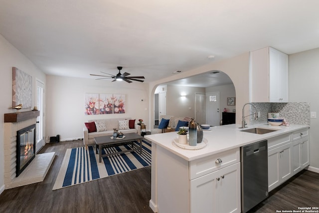 kitchen featuring white cabinets, stainless steel dishwasher, dark wood-type flooring, and sink